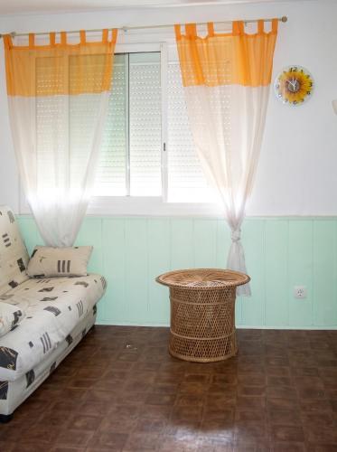 a living room with a couch and a window at Studio confortable à Valras-Plage de 26 m² in Valras-Plage