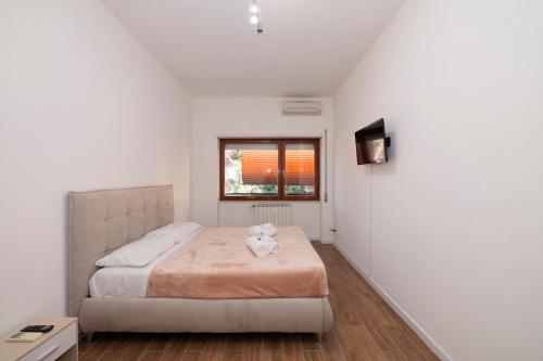 a bedroom with a bed with a teddy bear on it at ArticOstia in Lido di Ostia