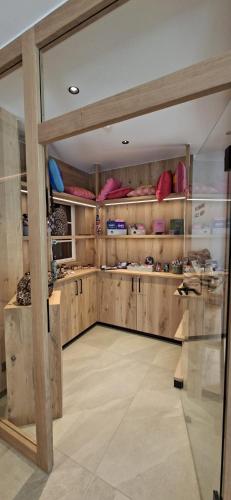 a room with wooden walls and shelves with shoes at Hotel Wiedemann in Füssen