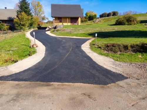 a winding road in front of a house at Chalet charmant à Saint-Gènes-Champespe avec parking privé in Saint-Genès-Champespe