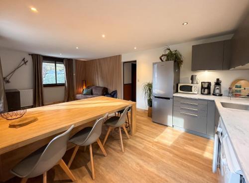 a kitchen with a large wooden table and chairs at Maison cosy à Cauterets avec vue sur les montagnes et jardin in Cauterets