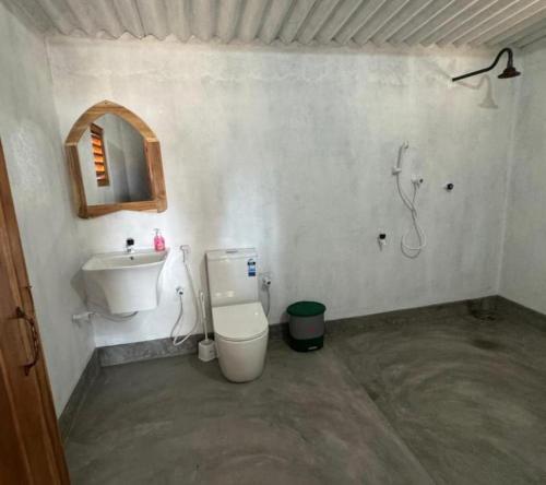 a bathroom with a toilet and a sink at Peanut Farm Cabanas -Surf in Panama