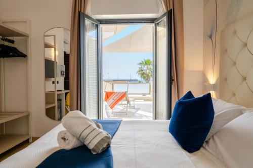 a bedroom with a bed with a view of the ocean at Hotel Tenda Rossa in Marina di Carrara