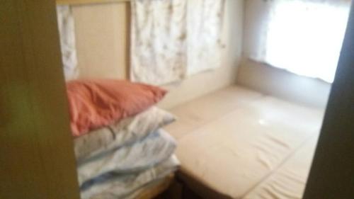 a small room with a bed and a window at Gradishte beach Ohrid in Ohrid