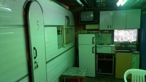 an old kitchen with white appliances and a window at Gradishte beach Ohrid in Ohrid