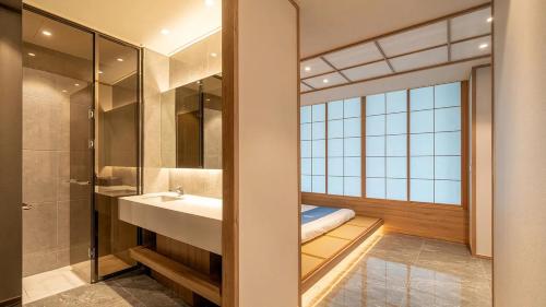 a bathroom with a sink and a shower at Hotel Opus in Gyeongju