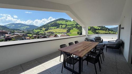 a room with a table and chairs and a large window at Mountain Inn - Hochquartier - Wildschönau in Niederau
