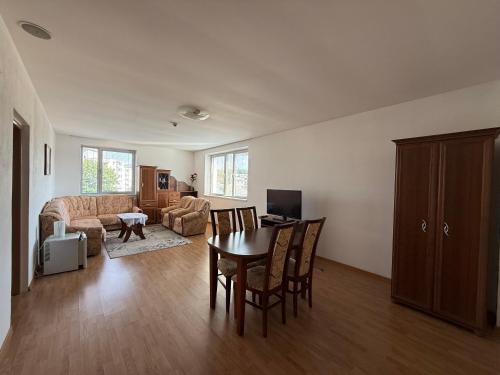 a living room with a table and chairs and a couch at Penzión Terno in Považská Bystrica