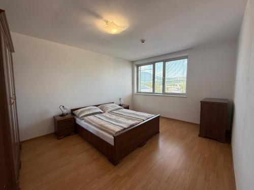 a bedroom with a bed and a window at Penzión Terno in Považská Bystrica