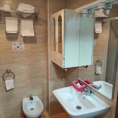 a bathroom with a sink and a mirror at Hostal Adelia in A Coruña