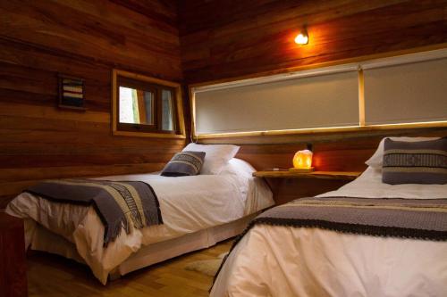 מיטה או מיטות בחדר ב-Los Lingues Lodge