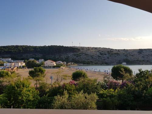 a view of a body of water with a beach at Apartments by the Sea in Lopar