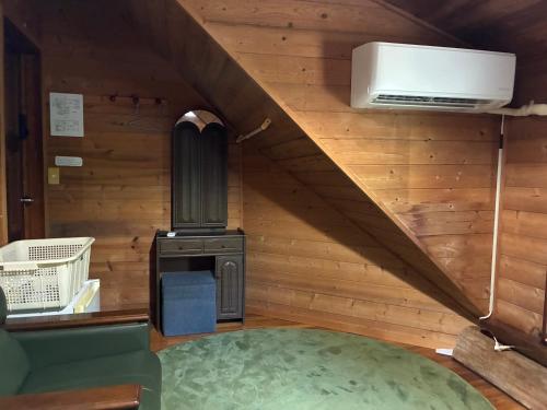 a small kitchen with a stove in a tiny house at PrivateVillaHutamiLog in Nago