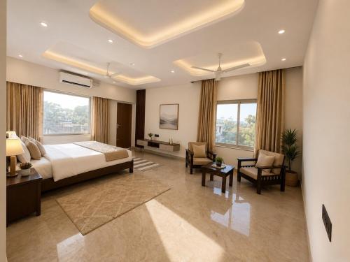 a bedroom with a bed and a desk and chairs at Private Farm with Big Size Pool & 7 Rooms in Kukas in Jaipur