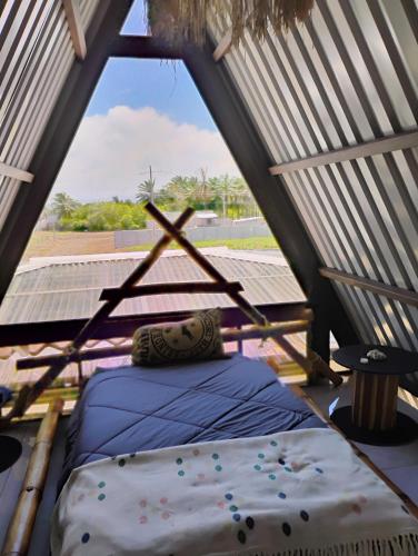 a room with a bed in a tent at A-frame cabin in Parrita