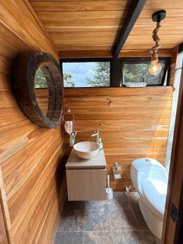 a bathroom with a sink and a toilet at Cabaña Con Jacuzzi Privado y Vista a La Montaña in Guarne