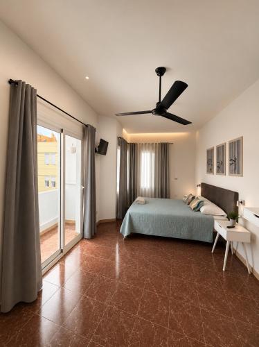 a bedroom with a bed and a ceiling fan at Tamonante rooms in Gran Tarajal