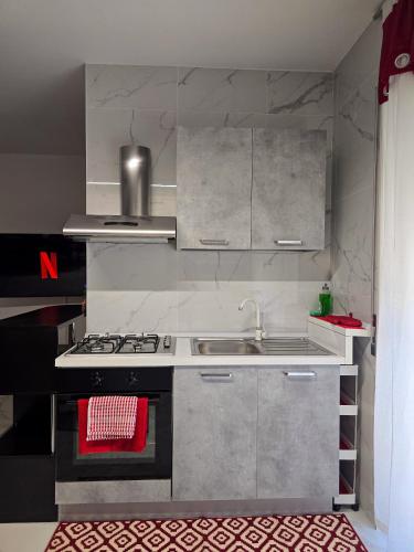 a kitchen with a sink and a stove top oven at Ca' di Sara in Domodossola