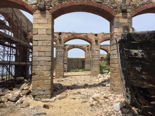 an old brick building with arches in the middle at B&B BentueMari in Portoscuso