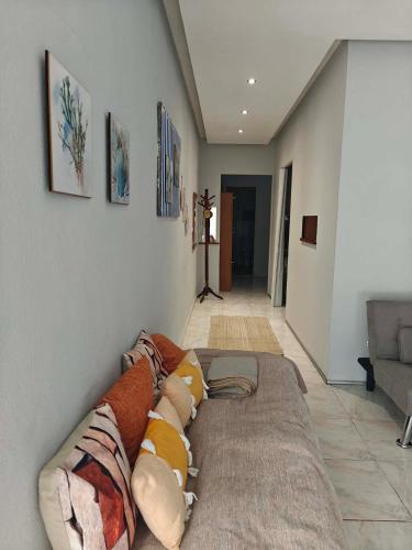 a couch with pillows on it in a living room at Irene's home in Igoumenitsa