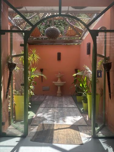 an enclosed courtyard with plants in a building at MSC Sport Campus in Marrakesh