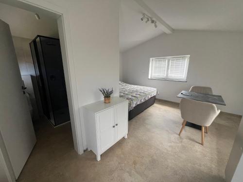 a bedroom with a bed and a desk and a chair at Olive Garden Studio in Izola