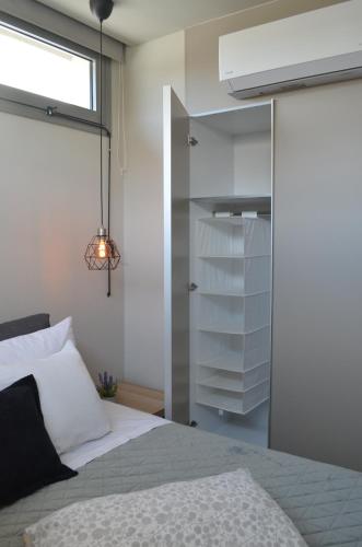 a bedroom with a bed and a sliding glass door at Downtown apartment - Signature in Kamena Vourla