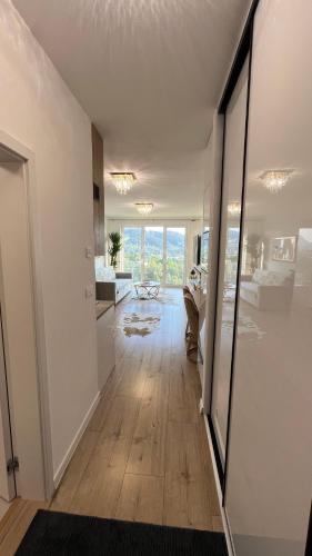 a living room with white walls and a hard wood floor at Sweet Dream in Dolný Kubín