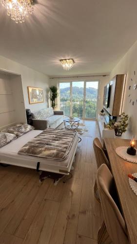 a large bedroom with a large bed and a table at Sweet Dream in Dolný Kubín
