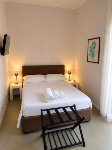 a bedroom with a bed with two towels on it at Nice Sea Suite in Salerno