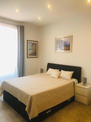 a bedroom with a large bed with two pillows at Summer Home No. 8 in Fažana