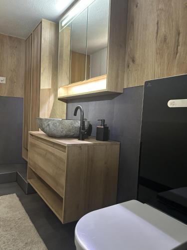 a bathroom with a sink and a toilet at Chalet Waldhüsli - CharmingStay in Quarten