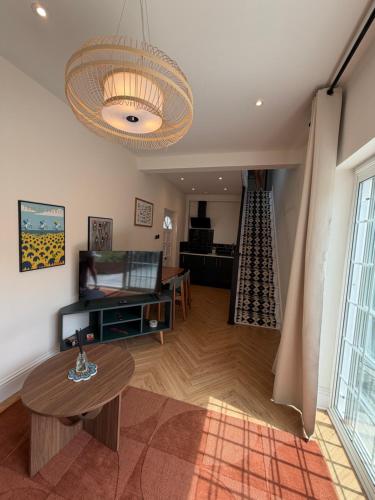 a living room with a table and a couch at Peaceful Self-Contained Apartment in Beckenham