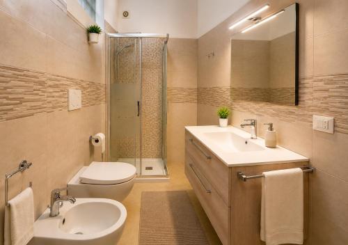 a bathroom with a toilet and a sink and a shower at Monte Cuccu Bed & Breakfast in Cerfignano