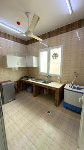 a kitchen with a sink and a window at شقة صحلنوت in Salalah