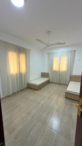 an empty room with two beds and a ceiling at شقة صحلنوت in Salalah