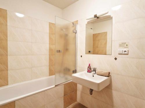 a bathroom with a sink and a shower at Apartmán Všemina 346 in Všemina
