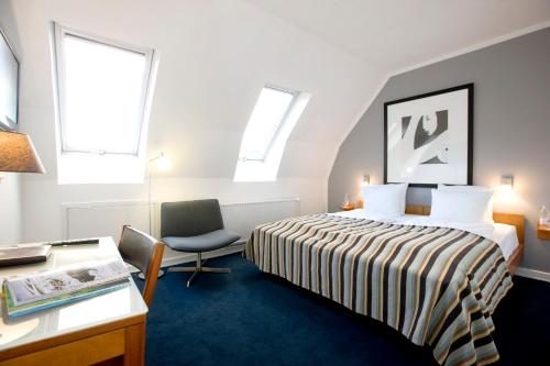 Tempat tidur dalam kamar di Hotel Christian IV