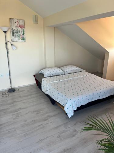 a bedroom with a bed and a lamp in it at Apartment Sunset in Šibenik