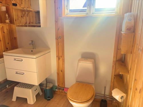 a small bathroom with a toilet and a sink at Sodra Fullsjön in Stugun