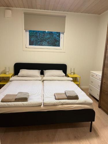 a bedroom with a bed with two towels on it at Basement apartment in Tokheim