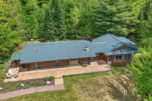 an overhead view of a large house with a blue roof at Lang Lodge cabin in Drummond