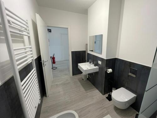 a bathroom with a white toilet and a sink at Marisabella Suite 6 - 8 - 12 in Bari