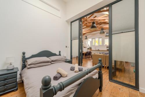 a bedroom with a bed and a large mirror at Ebenezer Hall in Falmouth