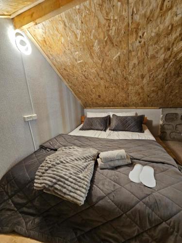 a bedroom with a large bed with a stone wall at Old Goris Hotel in Goris