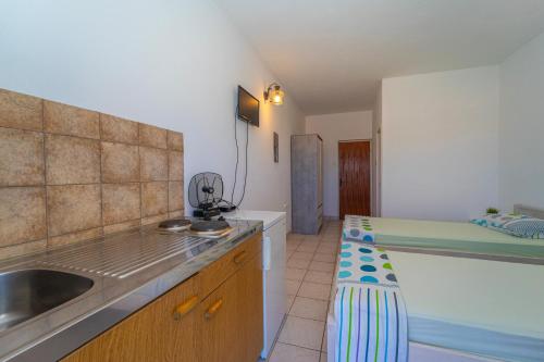 a kitchen with a sink and a counter top at Protić Apartments in Vela Luka