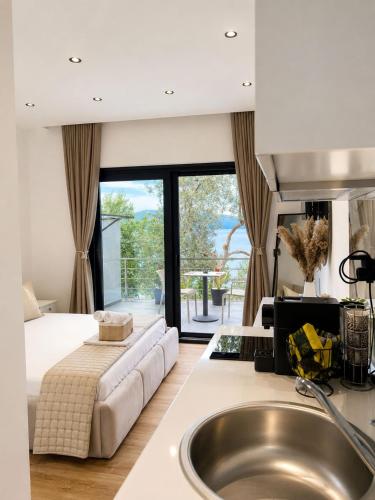 a kitchen with a sink and a bed in a room at Vila Dena in Vlorë