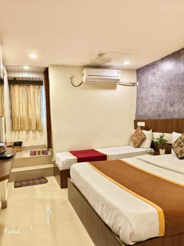 a hotel room with two beds in a room at AA Grand in Hyderabad
