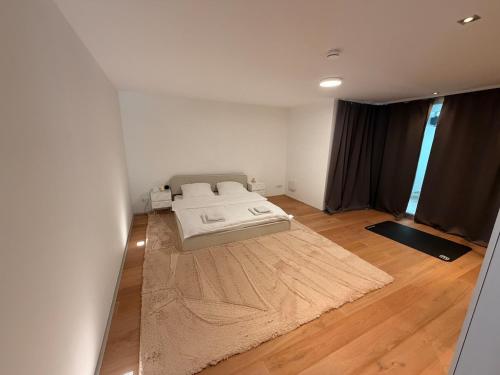a bedroom with a bed on a wooden floor at ThehiddenLakehouse Pool Sauna Whirlpool in Duisburg