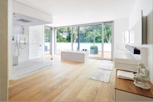 a white bathroom with a tub and a sink at ThehiddenLakehouse Pool Sauna Whirlpool in Duisburg